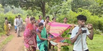 Pregnant Woman Carried on Cot